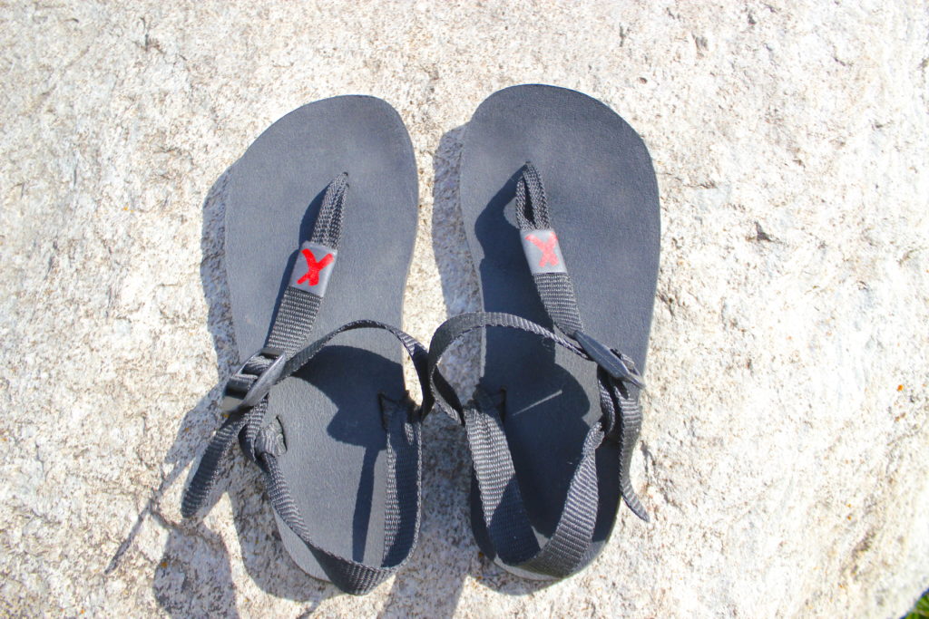 Xenet barefoot sandals on a rock