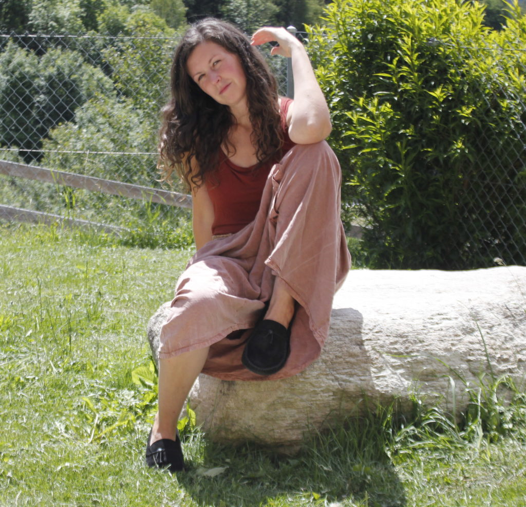 woman sitting outside wearing barefoot shoes